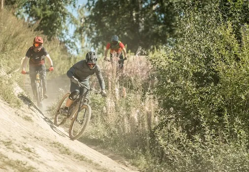 three cyclists going downhill